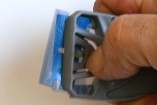 Scraperite holder with plastic razor blade lock